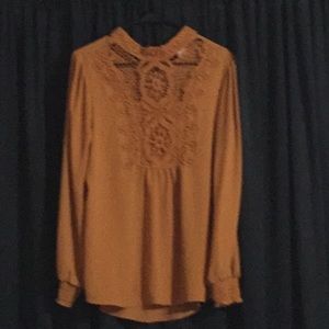 Mustard long sleeve blouse with lace on the front.